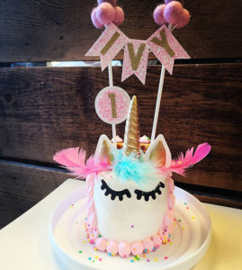 Unicorn Cake: Whipped cream cheese frosting, non-edible unicorn topper (style may vary), scalloped style hair on sides and back of the cake. Unicorn hair can be a single color or any color combo.